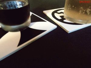 shot glass and beer glass on iron cross and sunwheel coasters